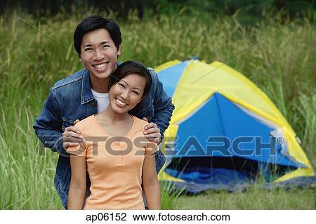 Couple with tent in the background, portrait View Large Photo Image Stock Image - Couple with tent in the background, portrait. Fotosearch