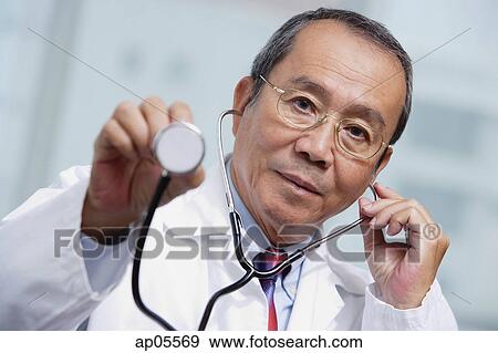 Doctor using stethoscope View Large Photo Image Stock Photo - Doctor using stethoscope. Fotosearch