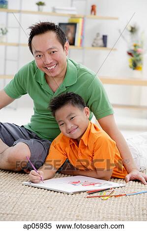 Father and son in living room, smiling at camera, portrait View Large Photo Image Stock Photography - Father and son in living room, smiling at camera, portrait. Fotosearch