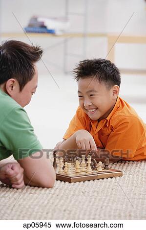 Father and son playing chess View Large Photo Image Stock Photography - Father and son playing chess. Fotosearch