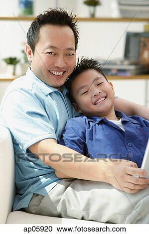 Father and son smiling at camera, portrait View Large Photo Image Stock Image - Father and son smiling at camera, portrait. Fotosearch
