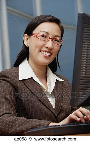 Female executive with computer, smiling at camera View Large Photo Image Stock Photo - Female executive with computer, smiling at camera. Fotosearch