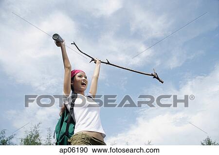 Female hiker, holding hiking stick in air, smiling View Large Photo Image Stock Image - Female hiker, holding hiking stick in air, smiling. Fotosearch