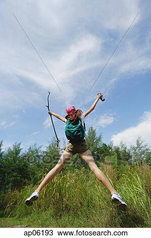 Female hiker, jumping, arms outstretched View Large Photo Image Stock Image - Female hiker, jumping, arms outstretched. Fotosearch