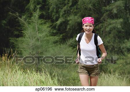 Stock Photograph - Female hiker, running. Fotosearch