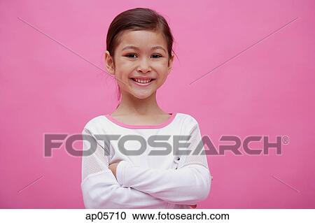 Girl looking at camera, arms crossed, smiling View Large Photo Image Stock Image - Girl looking at camera, arms crossed, smiling. Fotosearch