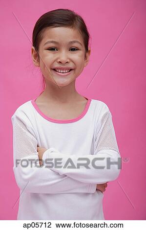 Girl smiling at camera, arms crossed View Large Photo Image Stock Image - Girl smiling at camera, arms crossed. Fotosearch