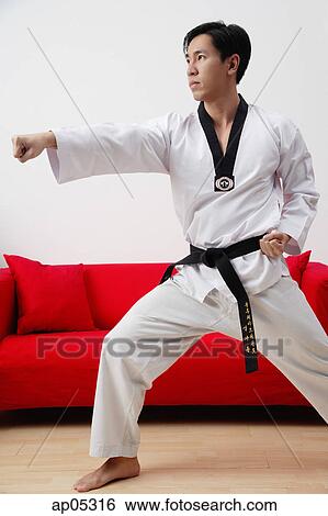Man at home practicing martial arts View Large Photo Image Stock Photograph - Man at home practicing martial arts. Fotosearch