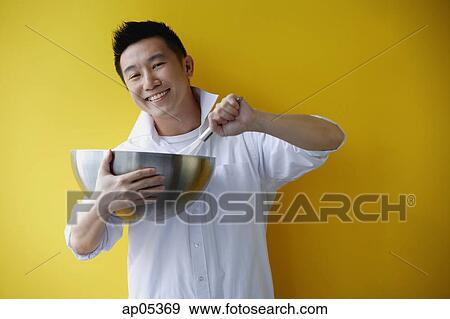 Man holding bowl and whisk View Large Photo Image Stock Photo - Man holding bowl and whisk. Fotosearch