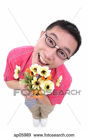Man holding flower bouquet, smiling at camera View Large Photo Image Stock Photo - Man holding flower bouquet, smiling at camera. Fotosearch