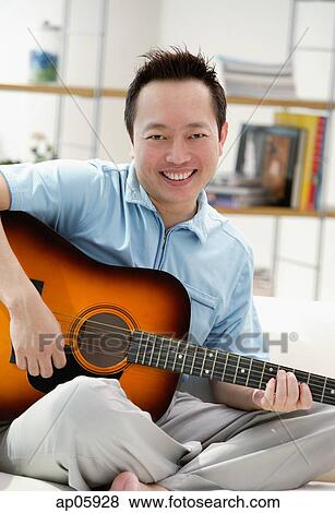 Man holding guitar View Large Photo Image Stock Photo - Man holding guitar. Fotosearch