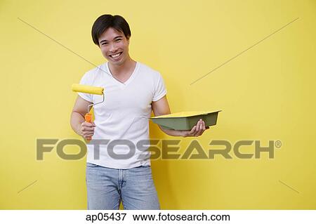 Man holding paint roller and paint tray View Large Photo Image Stock Photo - Man holding paint roller and paint tray. Fotosearch
