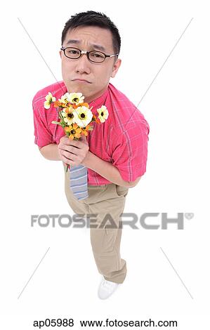 Man in shirt and tie holding flower bouquet, frowning View Large Photo Image Stock Photo - Man in shirt and tie holding flower bouquet, frowning. Fotosearch
