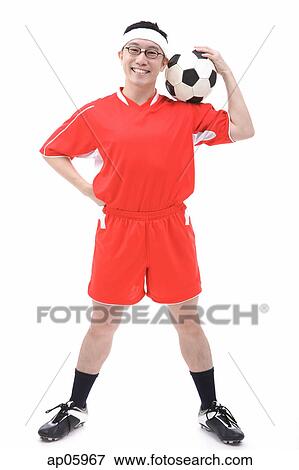 Man in soccer uniform holding soccer ball on shoulder View Large Photo Image Stock Photo - Man in soccer uniform holding soccer ball on shoulder. Fotosearch