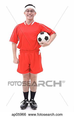 Man in soccer uniform holding soccer ball, portrait View Large Photo Image Stock Photograph - Man in soccer uniform holding soccer ball, portrait. Fotosearch
