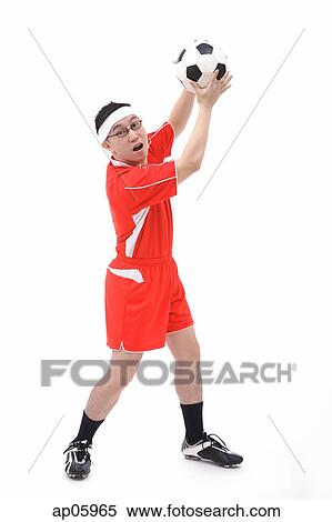 Man in soccer uniform holding soccer ball View Large Photo Image Stock Photography - Man in soccer uniform holding soccer ball. Fotosearch