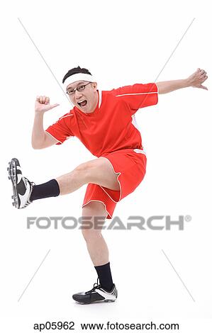Man in soccer uniform, kicking leg in air View Large Photo Image Stock Image - Man in soccer uniform, kicking leg in air. Fotosearch