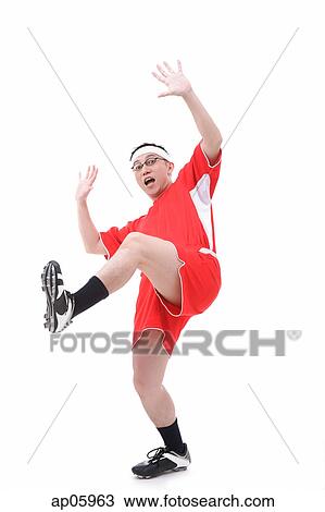 Man in soccer uniform, standing on one leg, shocked expression View Large Photo Image Stock Image - Man in soccer uniform, standing on one leg, shocked expression. Fotosearch