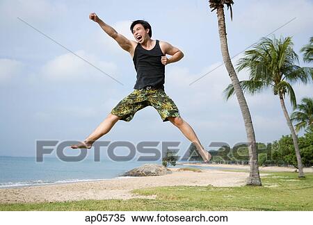 Man jumping in air, arms outstretched View Large Photo Image Stock Photography - Man jumping in air, arms outstretched. Fotosearch