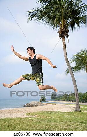 Stock Image - Man jumping in air. Fotosearch