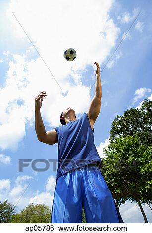 Man looking up at soccer ball View Large Photo Image Stock Photograph - Man looking up at soccer ball. Fotosearch