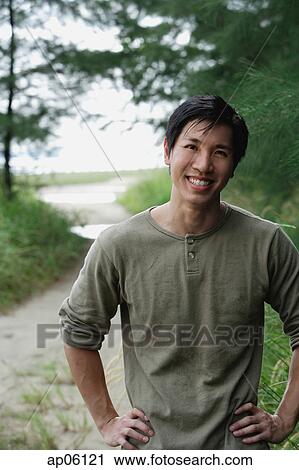 Stock Image - Man outdoors, smiling at camera. Fotosearch