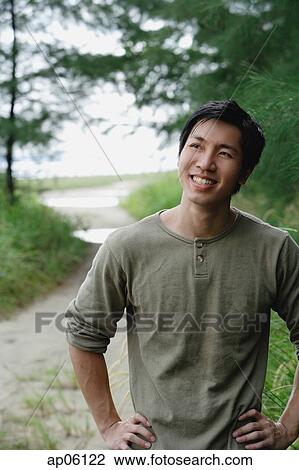 Man outdoors, smiling, hands on hip View Large Photo Image Stock Image - Man outdoors, smiling, hands on hip. Fotosearch