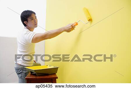Man painting wall with yellow paint View Large Photo Image Stock Photography - Man painting wall with yellow paint. Fotosearch