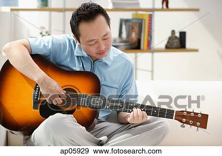 Man playing the guitar View Large Photo Image Stock Photo - Man playing the guitar. Fotosearch