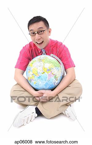 Man sitting on floor, hugging globe View Large Photo Image Stock Photo - Man sitting on floor, hugging globe. Fotosearch
