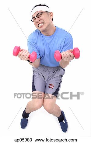 Stock Image - Man sitting on stool, lifting weights, grimacing. Fotosearch