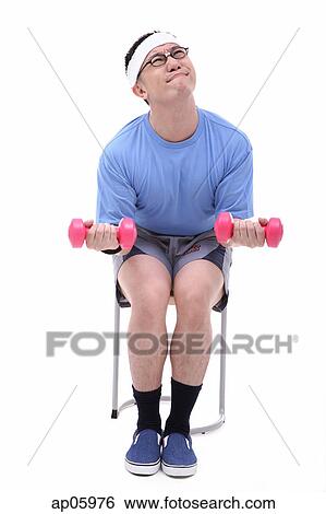 Man sitting on stool, lifting weights View Large Photo Image Stock Photograph - Man sitting on stool, lifting weights. Fotosearch