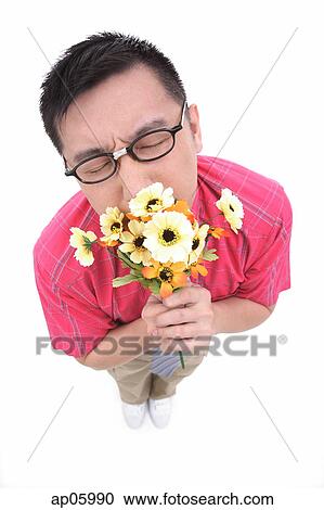 Man smelling flower bouquet View Large Photo Image Stock Image - Man smelling flower bouquet. Fotosearch
