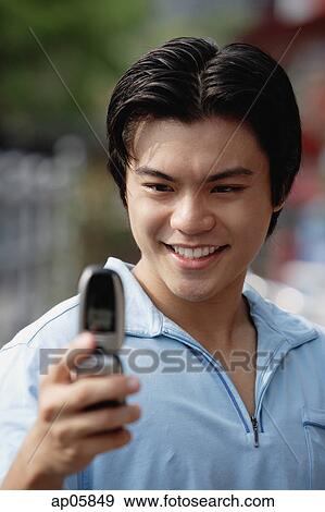 Stock Photo - Man using mobile phone, text messaging. Fotosearch