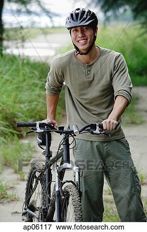 Man with bicycle, outdoors, portrait View Large Photo Image Stock Photo - Man with bicycle, outdoors, portrait. Fotosearch