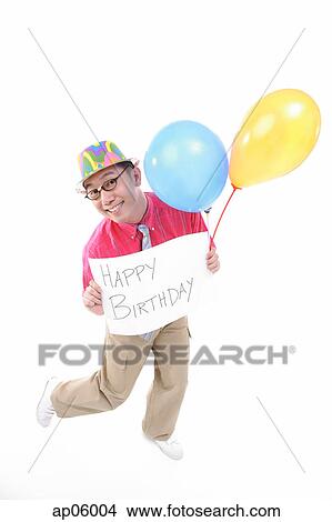 Man with party hat holding balloons and a sign View Large Photo Image Picture - Man with party hat holding balloons and a sign. Fotosearch