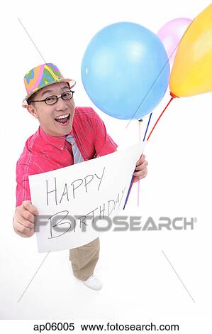 Man with party hat, holding balloons and a birthday greeting sign View Large Photo Image Stock Photography - Man with party hat, holding balloons and a birthday greeting sign. Fotosearch