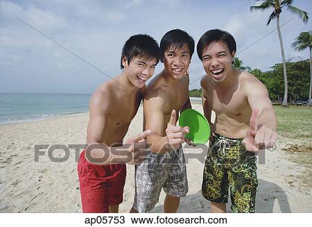 Men on beach, standing side by side, making hand sign View Large Photo Image Stock Image - Men on beach, standing side by side, making hand sign. Fotosearch
