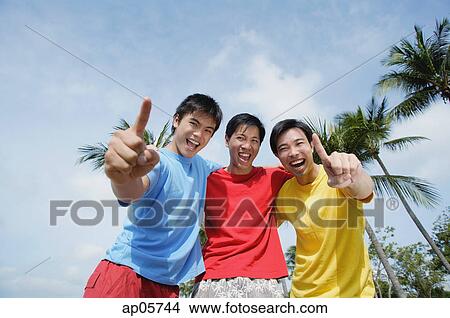Men with arms around each other, looking at camera, making hand sign View Large Photo Image Picture - Men with arms around each other, looking at camera, making hand sign. Fotosearch