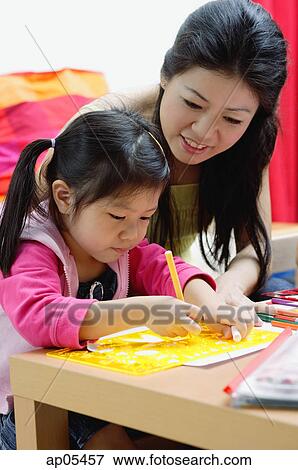 Mother and young daughter drawing at home View Large Photo Image Stock Photo - Mother and young daughter drawing at home. Fotosearch