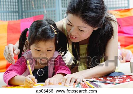 Mother drawing with young daughter View Large Photo Image Stock Photograph - Mother drawing with young daughter. Fotosearch