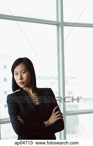 Stock Image - Portrait of businesswoman, arms crossed. Fotosearch