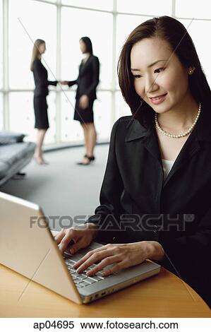 Stock Photography - Portrait of businesswoman using laptop. Fotosearch