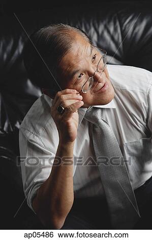 Senior man adjusting glasses View Large Photo Image Stock Photograph - Senior man adjusting glasses. Fotosearch