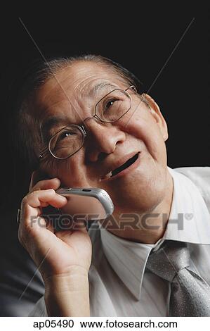 Senior man with mobile phone, looking up View Large Photo Image Stock Image - Senior man with mobile phone, looking up. Fotosearch