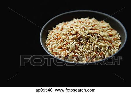 Still life of Bowl of rice against black background View Large Photo Image Stock Photo - Still life of Bowl of rice against black background. Fotosearch