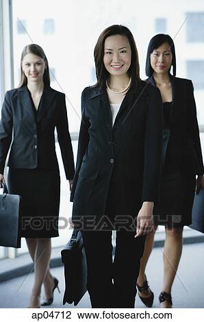 Three businesswomen, smiling at camera View Large Photo Image Stock Image - Three businesswomen, smiling at camera. Fotosearch