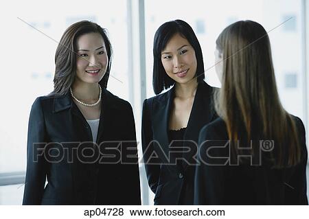 Three businesswomen, talking View Large Photo Image Stock Photo - Three businesswomen, talking. Fotosearch