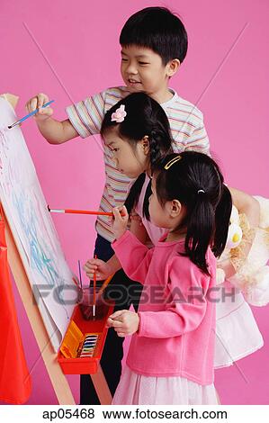 Stock Photo - Three children painting on easel. Fotosearch
