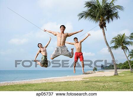 Three men jumping in air, arms outstretched View Large Photo Image Stock Photo - Three men jumping in air, arms outstretched. Fotosearch
